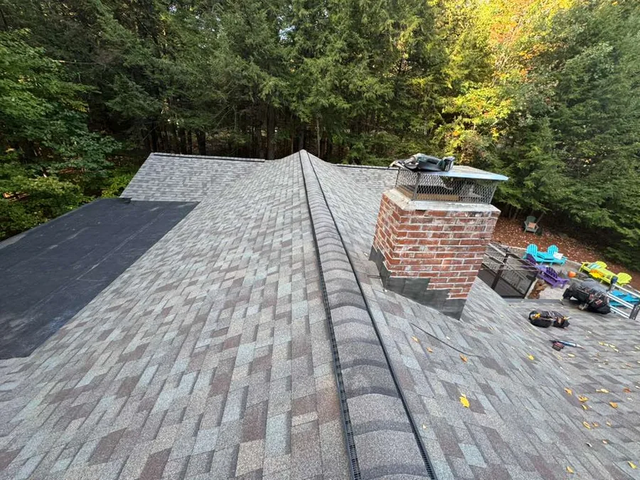 Repaired brick chimney with new cap and flashing on a home in Lowell, MA