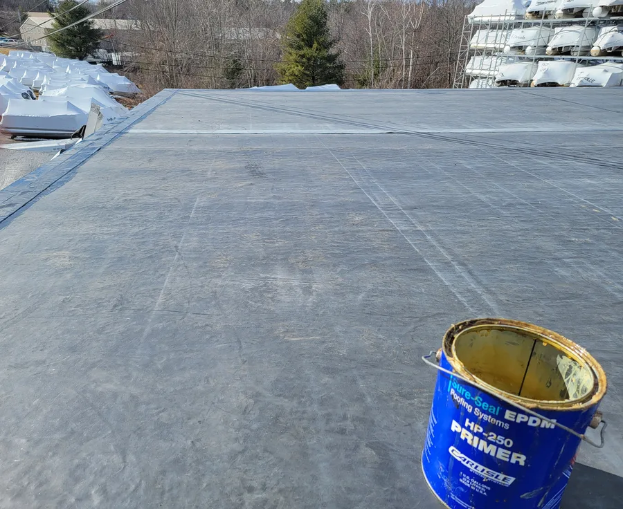EPDM rubber flat roof with a can of EPDM primer, Manchester, NH