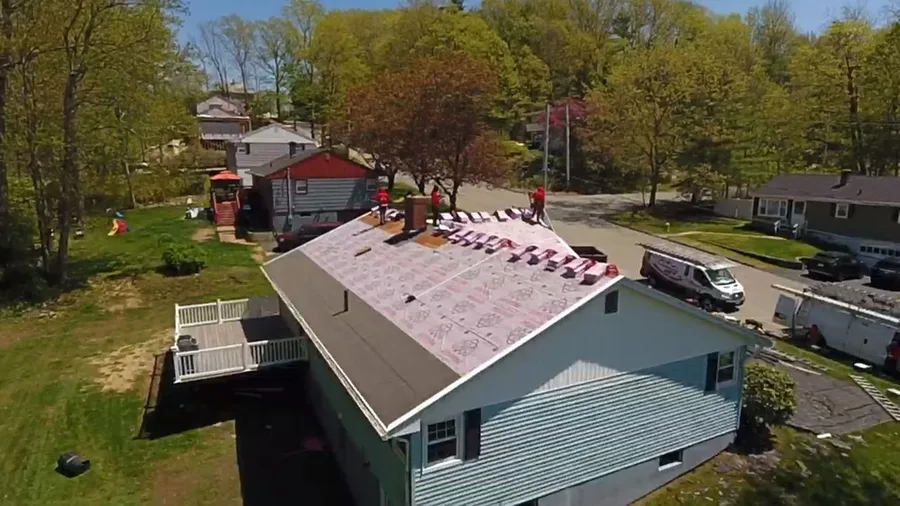 Aerial drone view of a roof replacement project in Lowell, MA