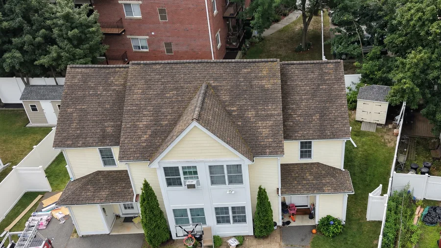 Roof in Lowell, MA before the replacement, showing the old worn shingles