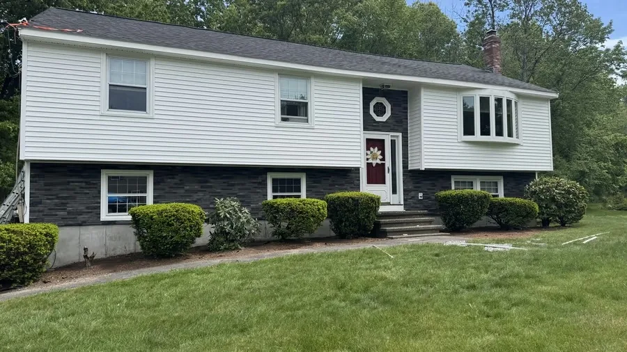 Same home in Lowell, MA after the siding replacement, with new vinyl siding installed