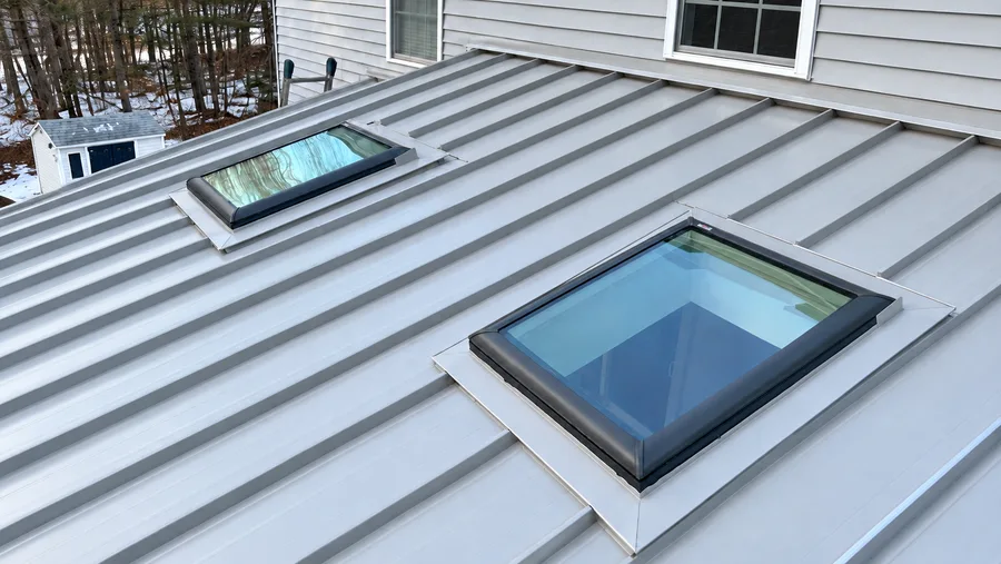 Same roof in Lowell, MA after skylight installation, with new skylight units sealed and flashed
