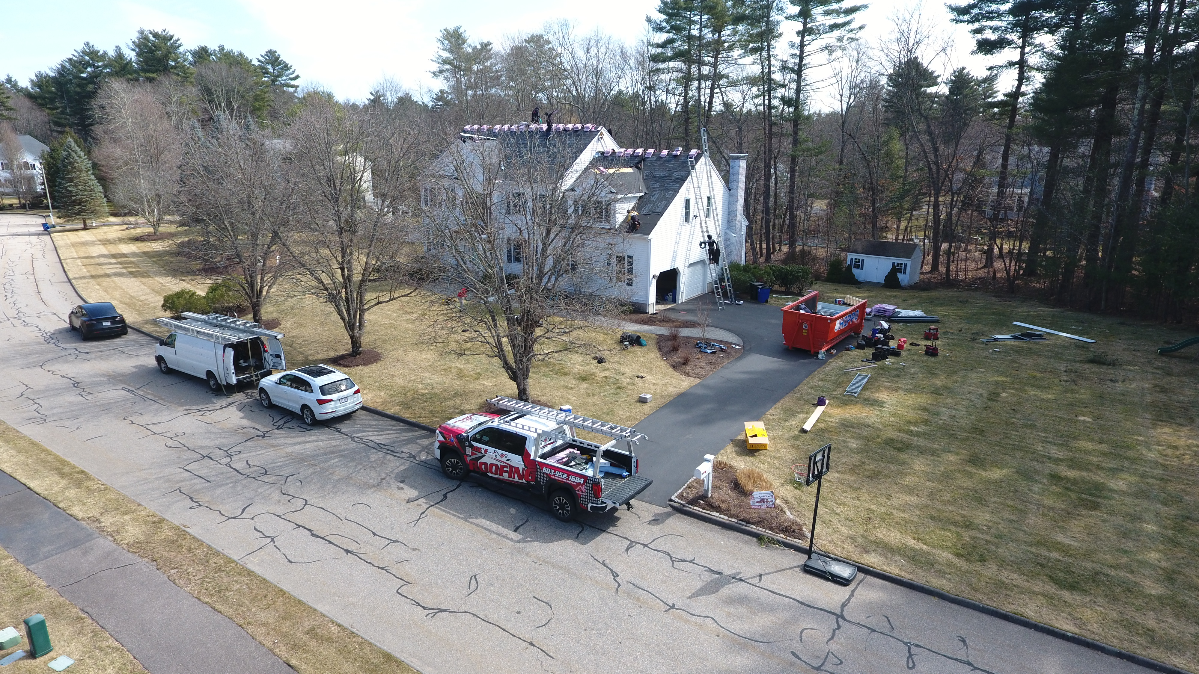 Licensed team performing roof deck repair on colonial home in Lowell Massachusetts
