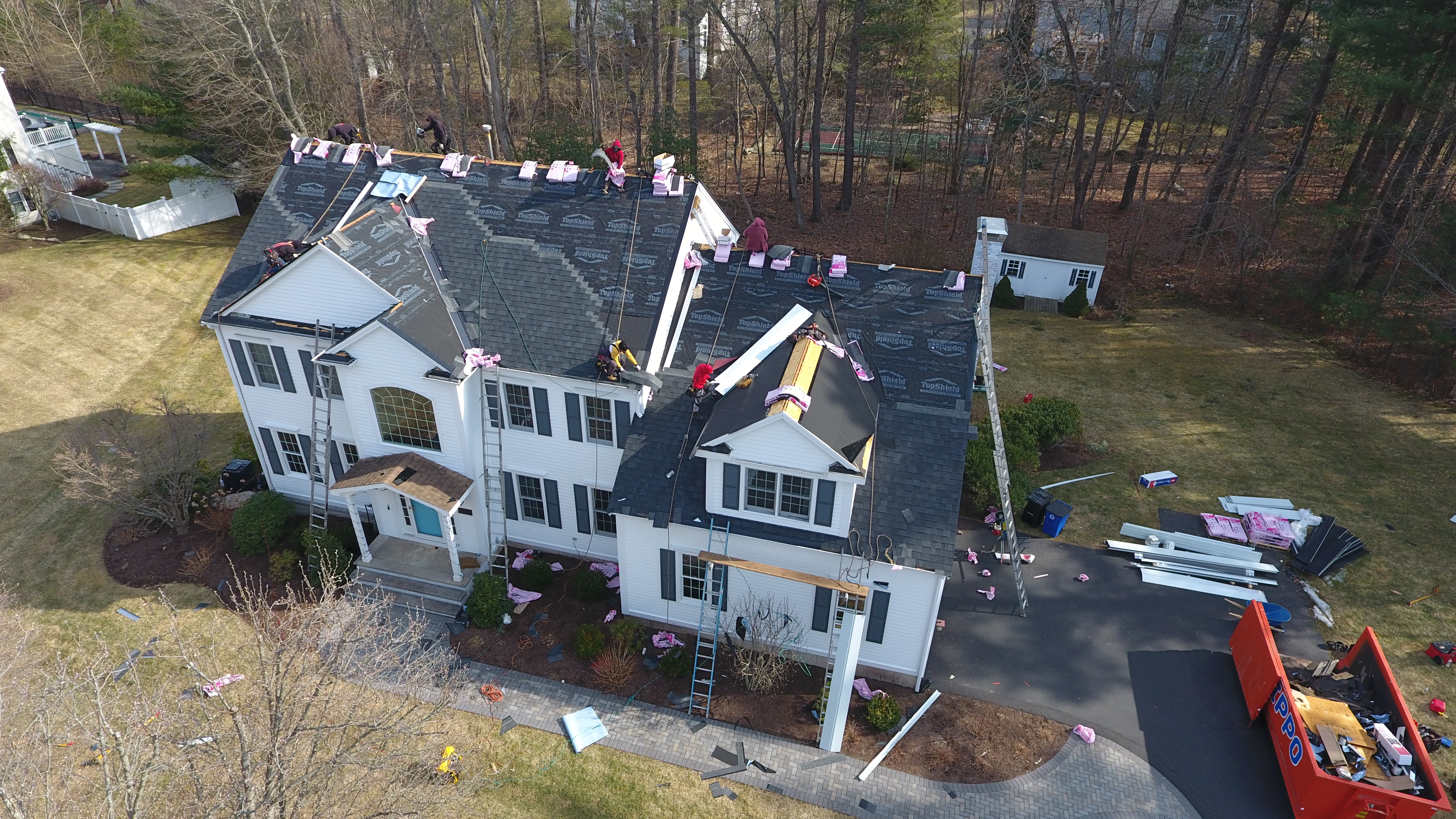 Skilled roofers performing complete roof system installation in Manchester NH