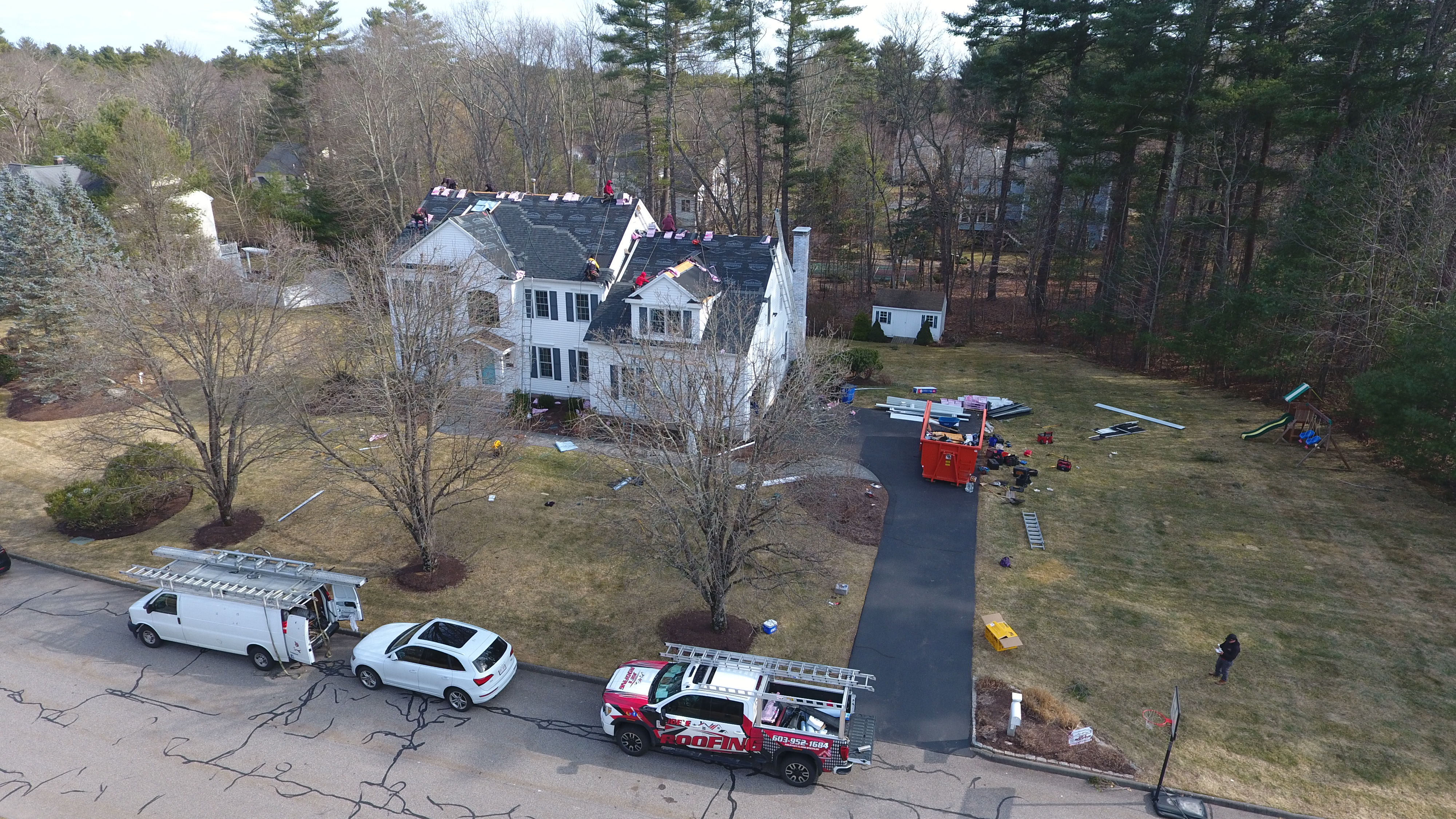 Licensed contractors replacing roof sheathing on damaged home in New Hampshire