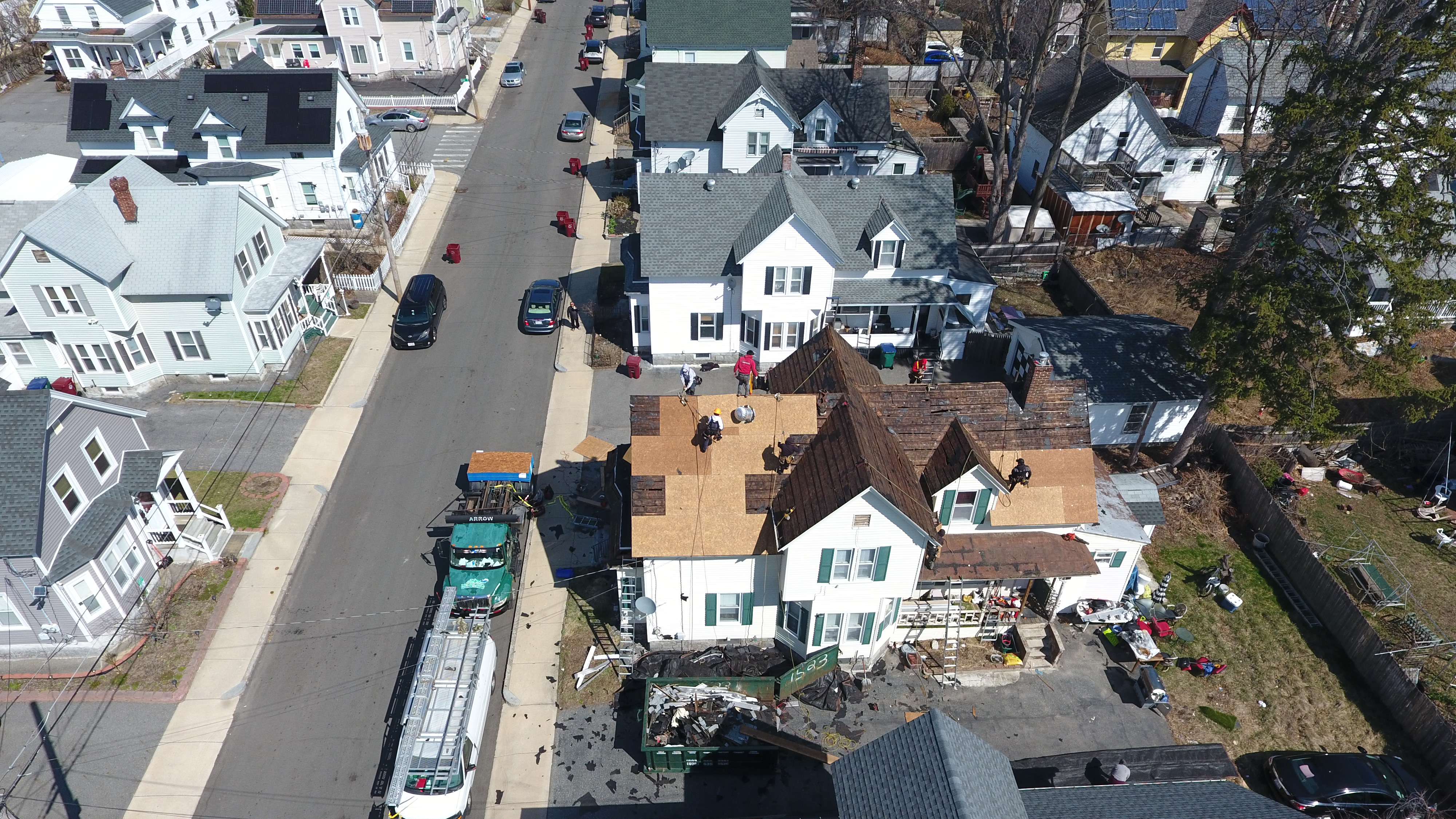 Skilled contractors performing roof tear-off and replacement on New Hampshire home
