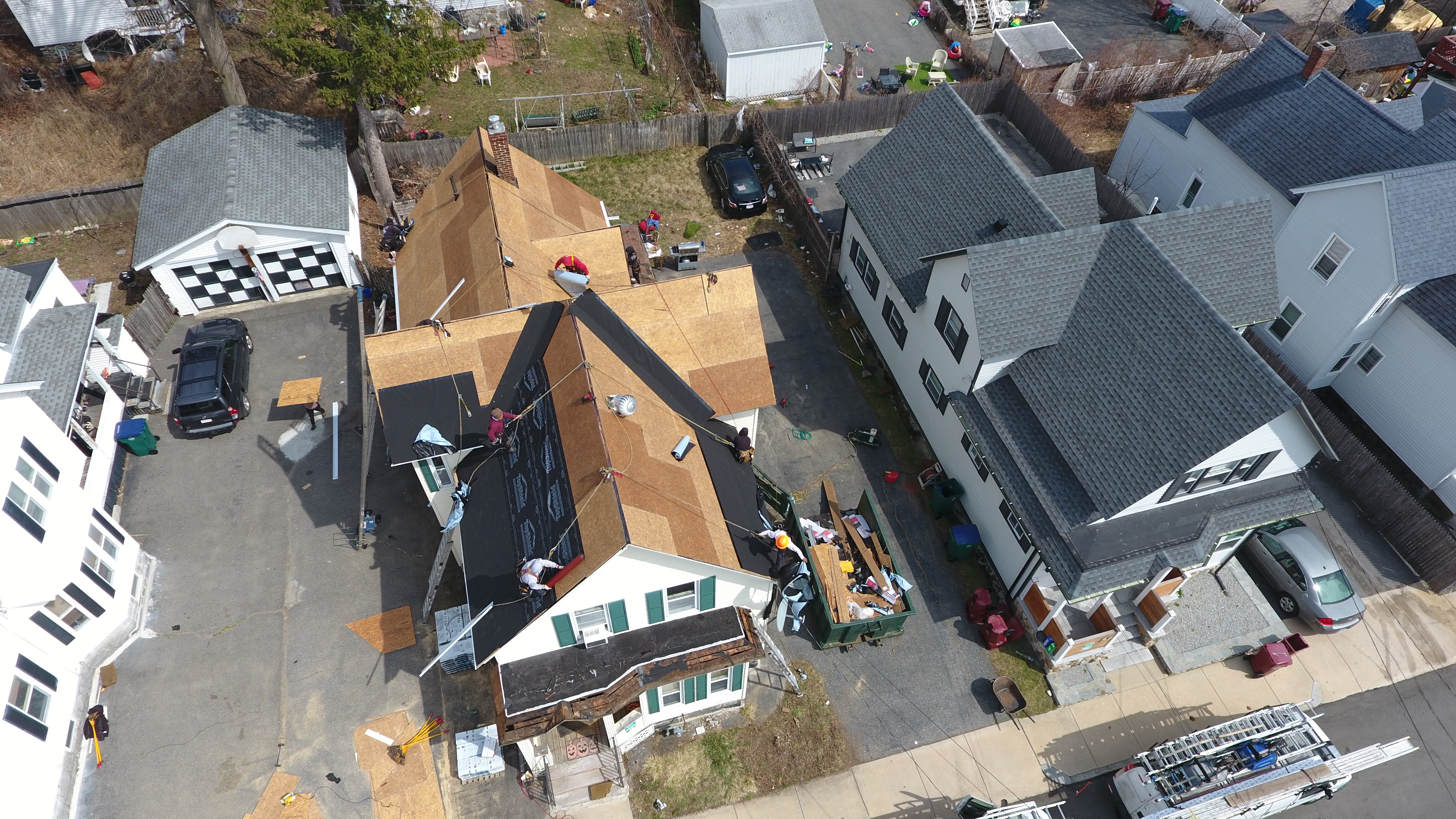 Â Professional team completing roof installation project in Massachusetts residential neighborhood