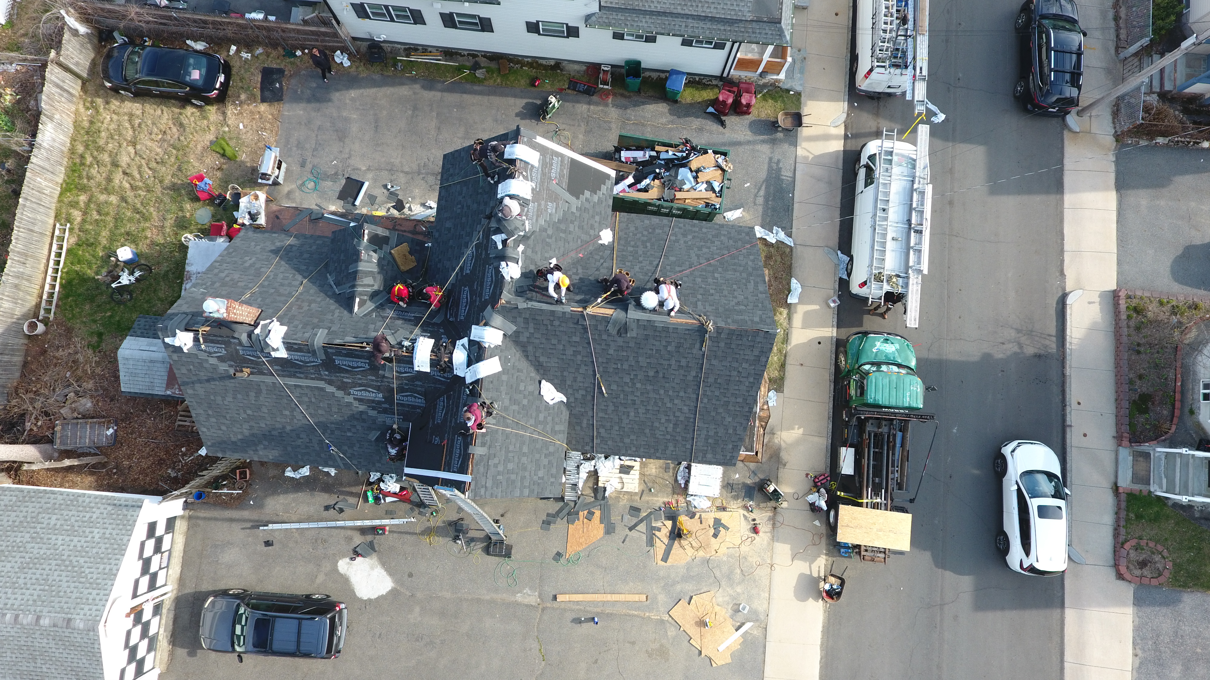 Licensed roofing crew performing emergency storm damage repairs in New Hampshire