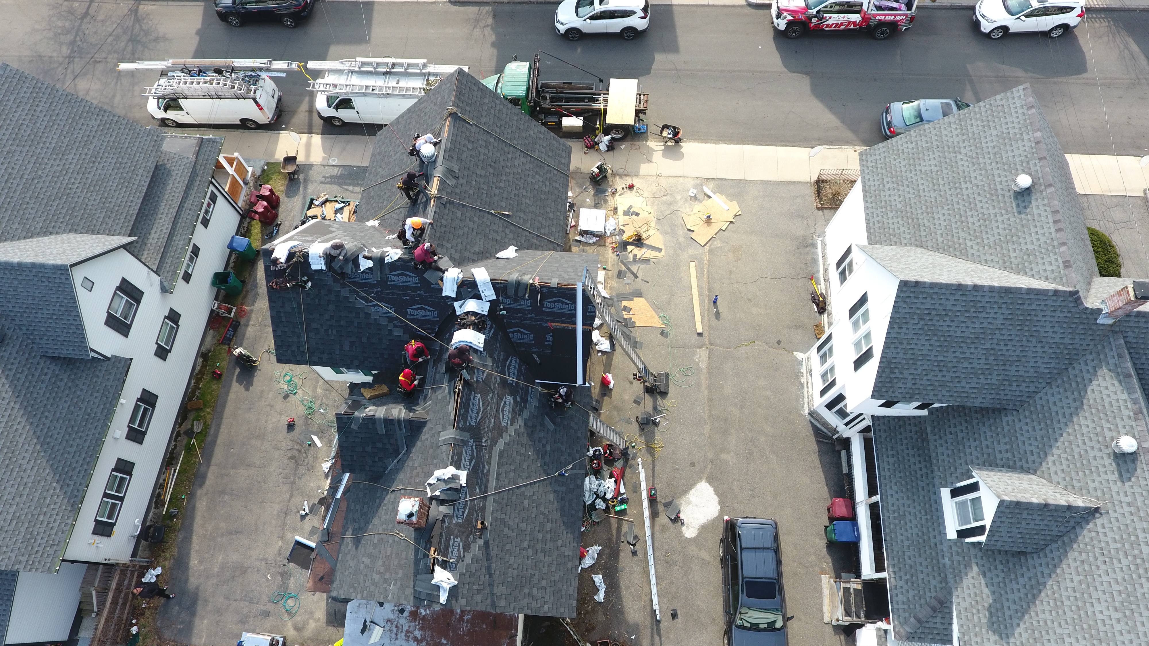 Certified professionals installing seamless aluminum gutters in Lowell Massachusetts