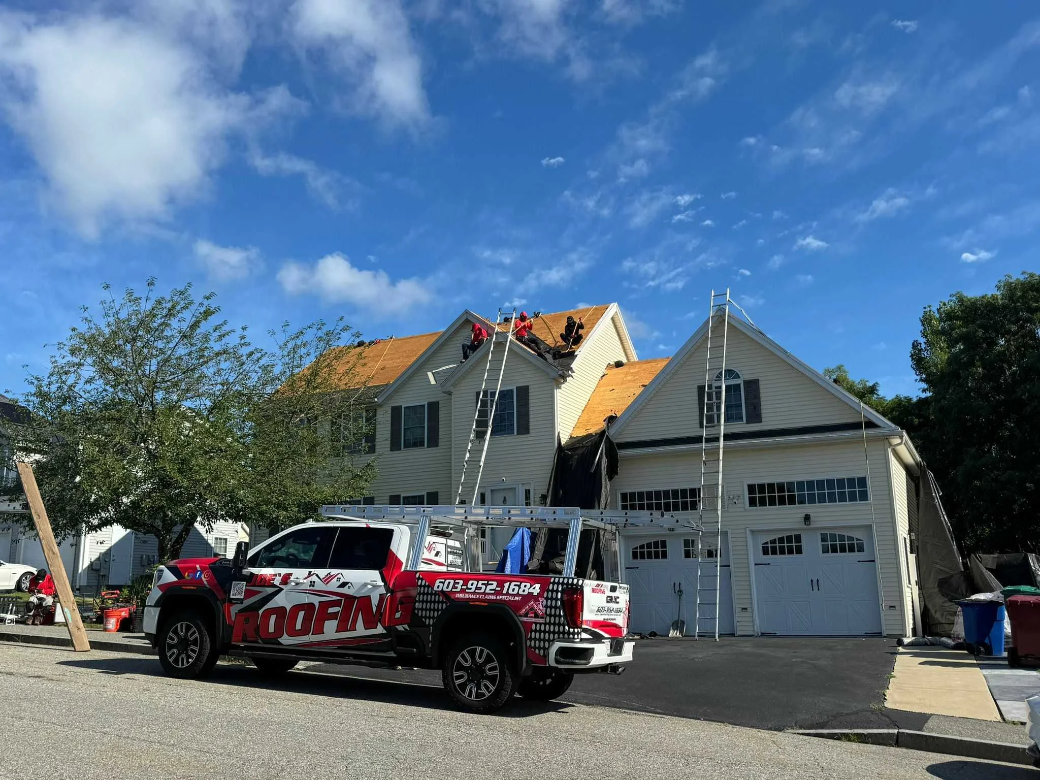 Roof repair crew replacing deteriorated fascia boards and rotted soffit material