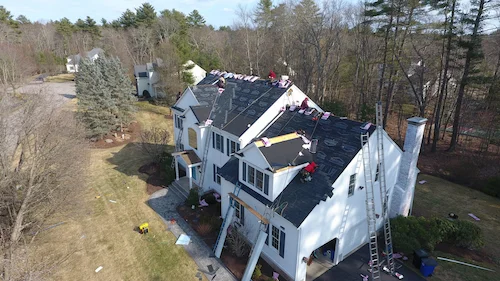 Insurance adjuster documenting hail damage on roof with Joe's Roofing specialist present