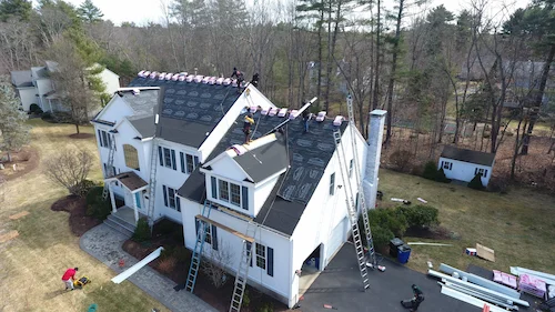 Vinyl siding replacement project in progress showing new siding installation over house wrap