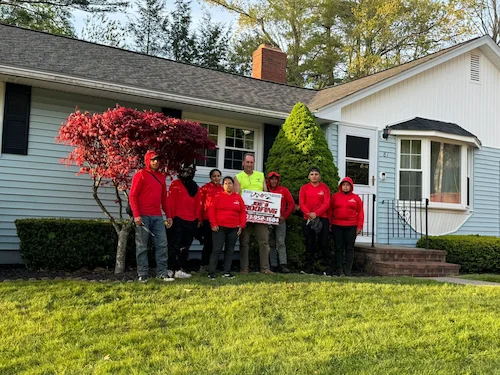 Gutter cleaning service removing debris and leaves from residential gutters in New Hampshire