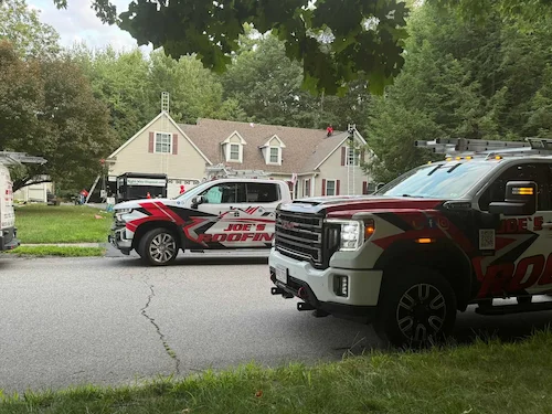 Missing asphalt shingles on residential roof exposing black underlayment after windstorm damage