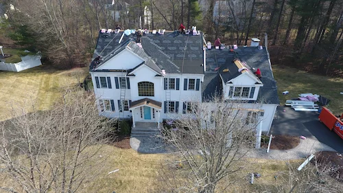 New cedar shake siding installation transforming home exterior appearance