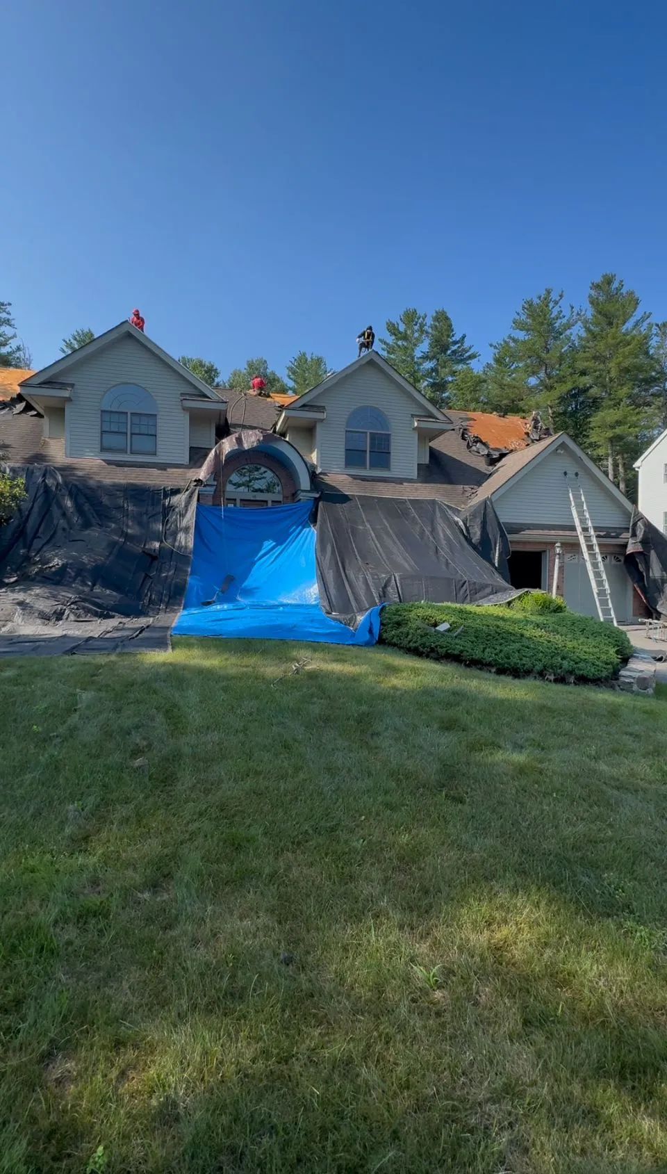 Professional siding installation contractors working on home exterior in New Hampshire