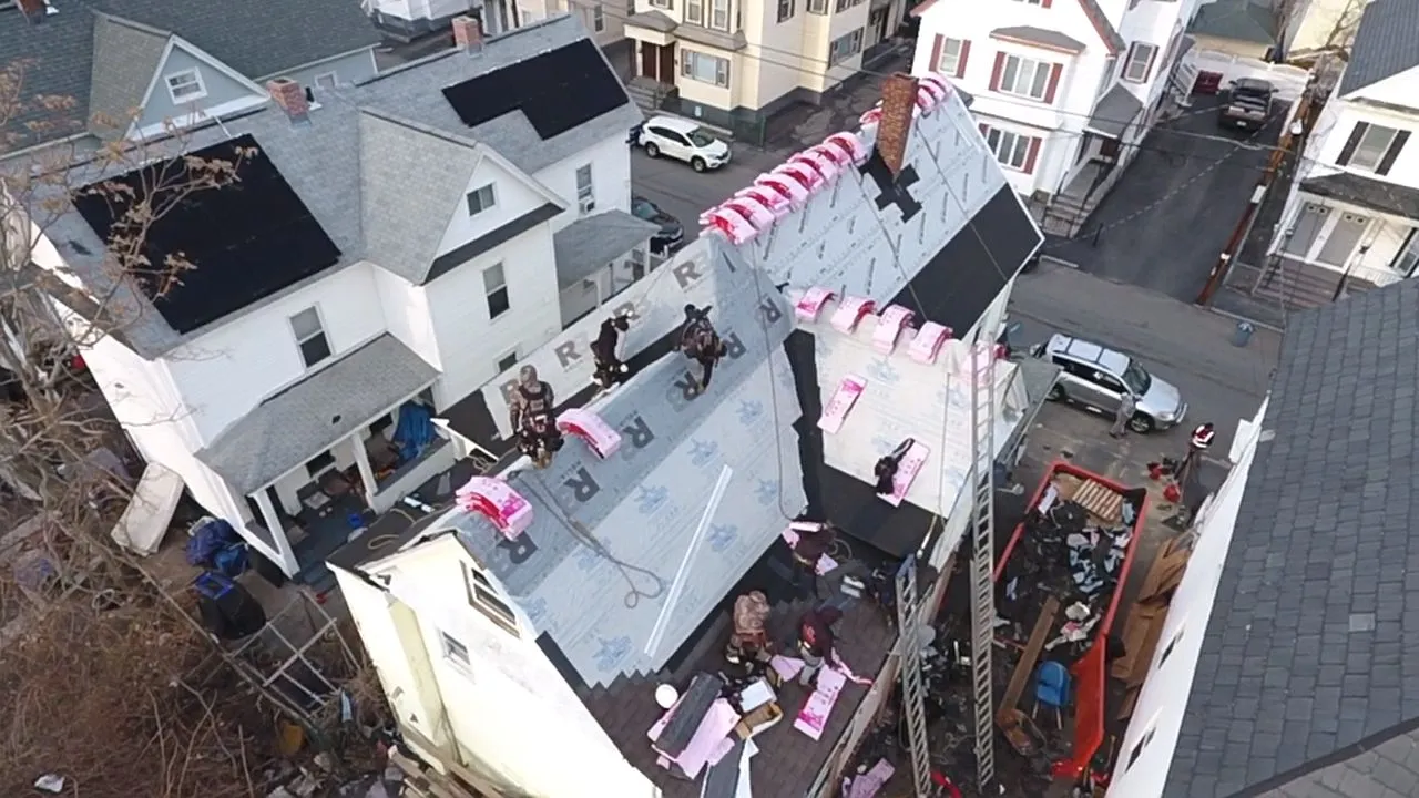 Skilled roofing contractors repairing roof leak and water damage in Lowell MA