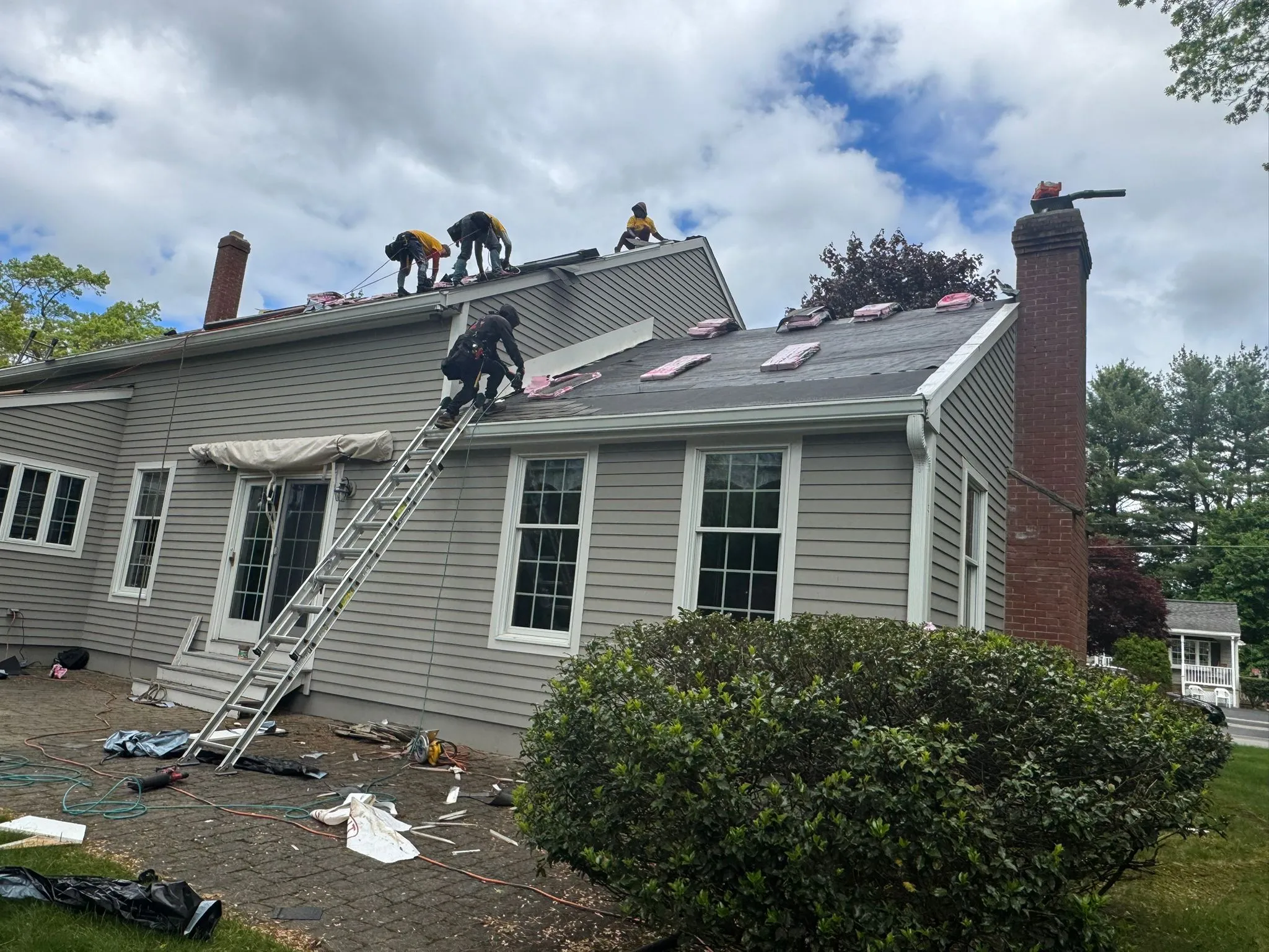 Licensed roofing team performing roof inspection and repair services in Lowell Massachusetts